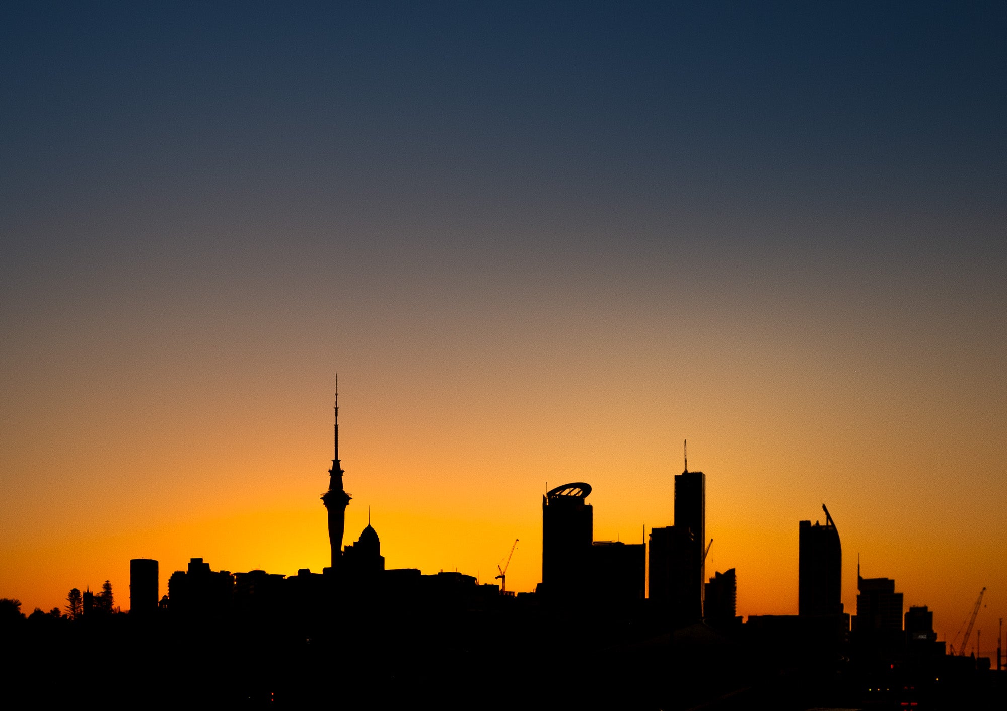 City skyline silhouette against a sunset sky