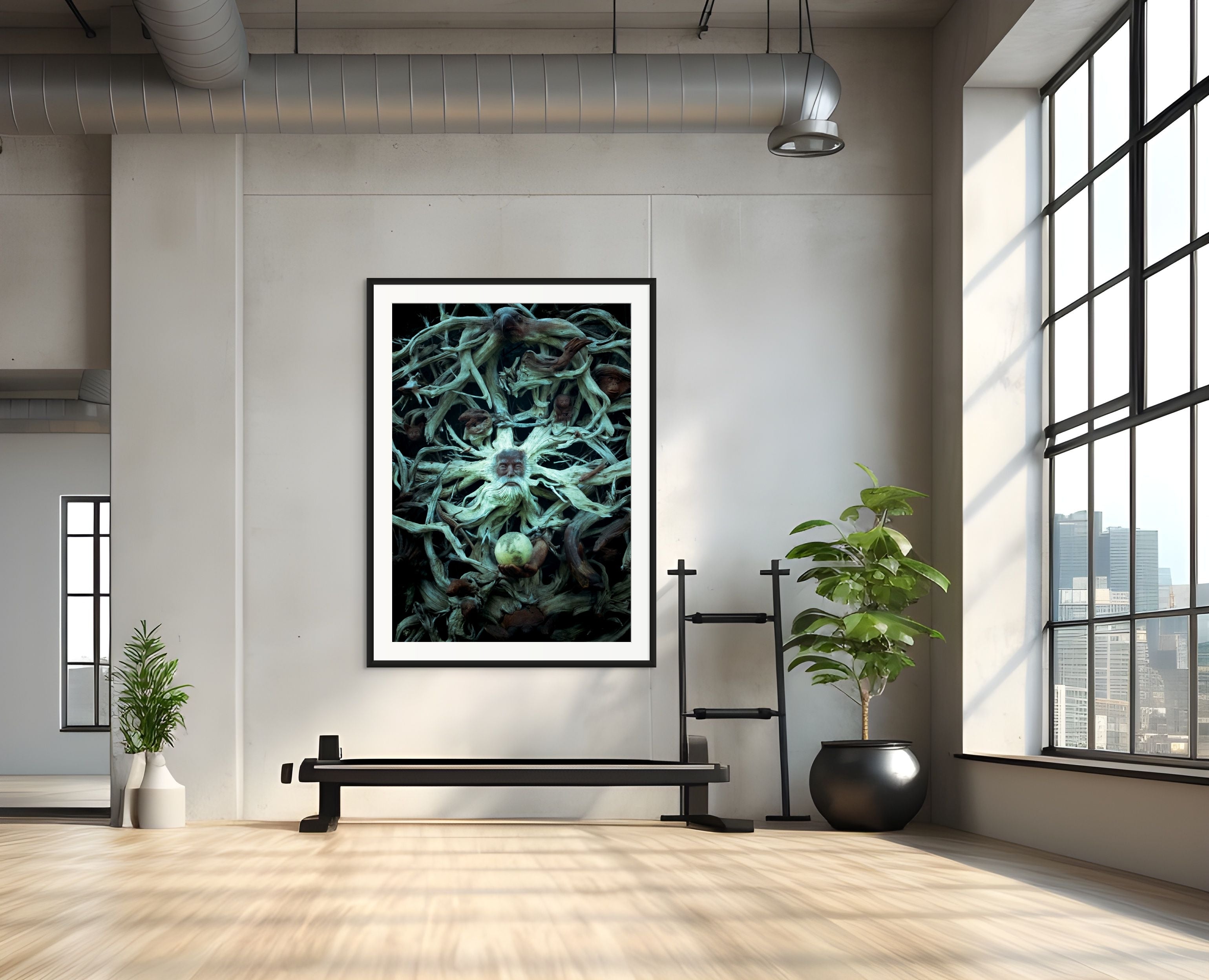 Framed artwork on a wall in a modern room with plants and a large window.
